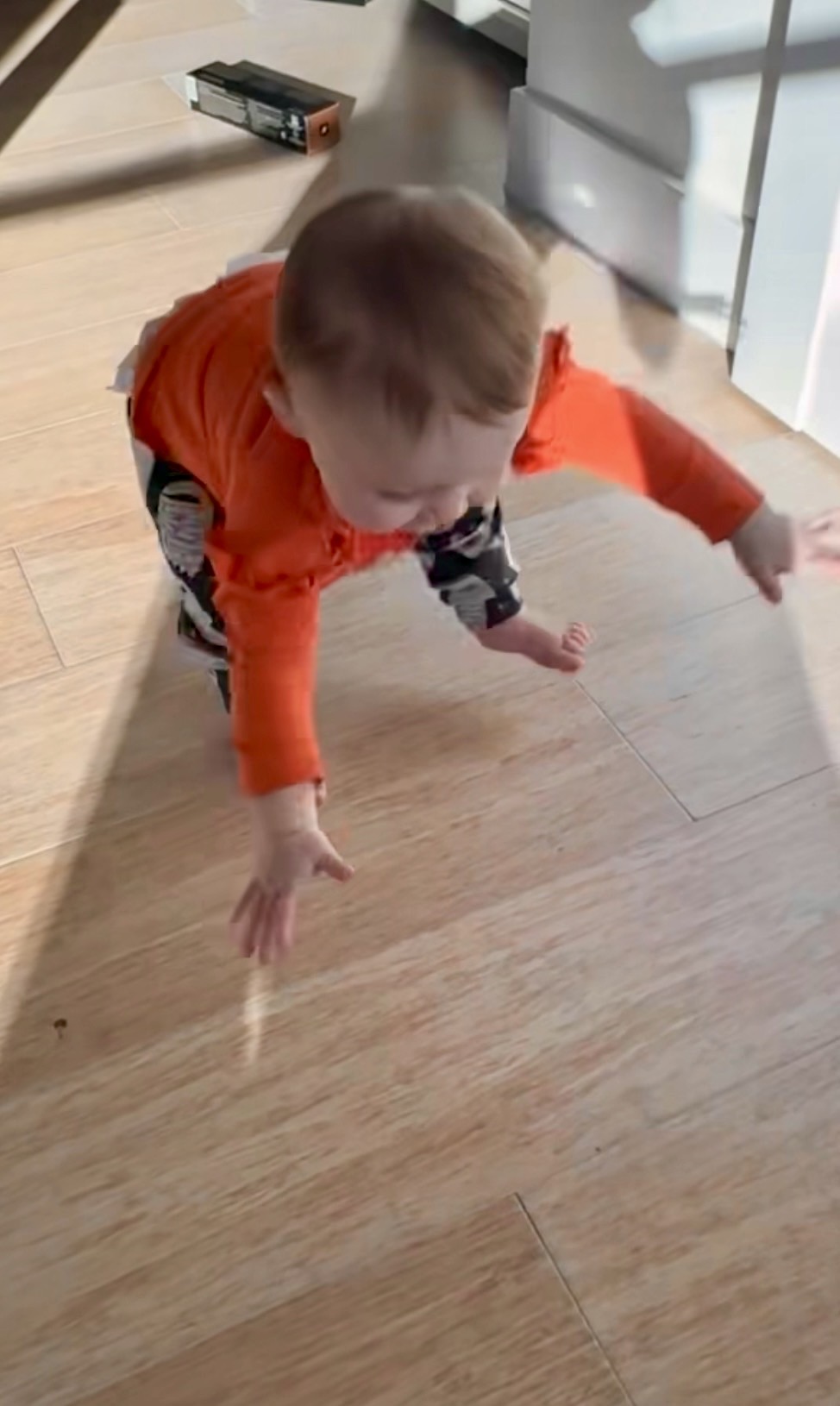 Mom watching toddler climb boulder — risky play and natural consequences in action